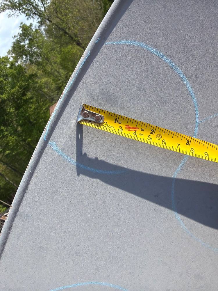 Tape measure documenting hail dent size on satellite dish during HAAG certified inspection