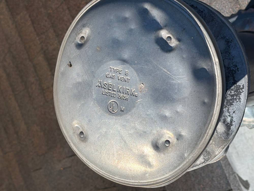 Multiple hail dents on galvanized gas vent cap, soft metal storm damage Virginia