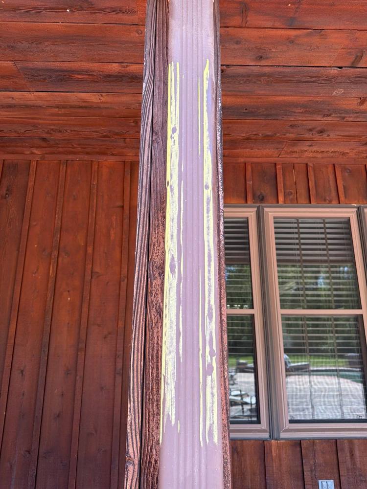 Hail spatter and strike marks on aluminum downspout chalked during inspection, Loudoun County Virginia
