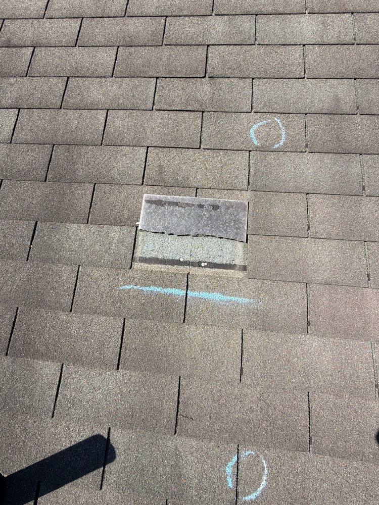 Missing shingle tab with exposed mat and nail line close-up, wind damage Fauquier County Virginia
